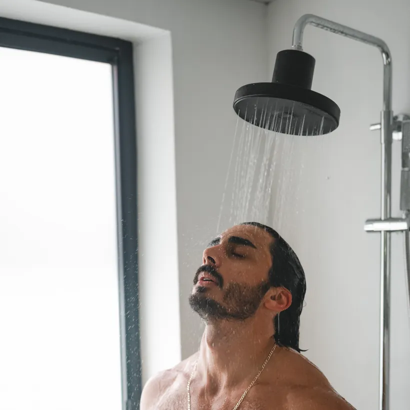 Customer showering with the matte black Ultimate Showerhead